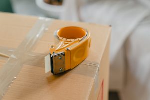 Packing tape gun on carton box